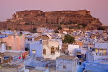 Elevated View Over Colorful Houses Of The Blue City Towards Meherangarh Fort, Jodhpur, Western Rajasthan