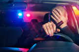 Fototapeta Tulipany - Sad man is caught driving under alcohol influence