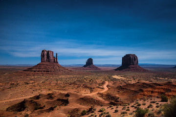 Wall Mural - monument valley illuminated in moonlight on a starry night, arizona, usa