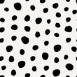 Seamless pattern with irregular dots in black on cream background.
