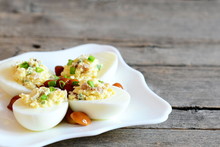 Basic Stuffed Eggs On A Plate Isolated On Old Wooden Background With Copy Space For Text. Hard-boiled Eggs Stuffed With Cheese, Mushrooms And Green Onions. Holiday Appetizer Recipe. Closeup