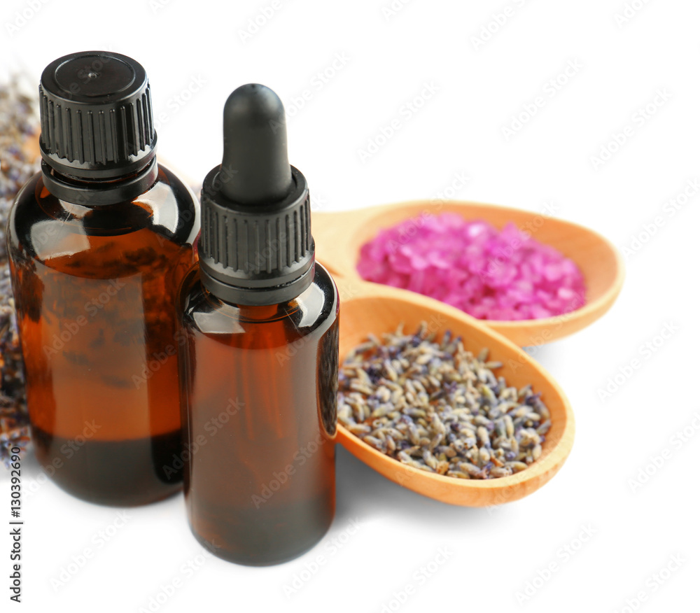 Essential oils, lavender and sea salt on white background