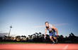 © Dewald - Male sprinter athlete on a tartan athletic track getting ready f