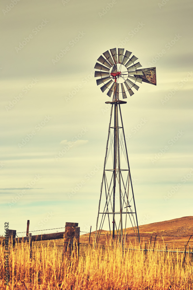 Retro toned windmill tower, American wild west symbol. Stock Photo ...
