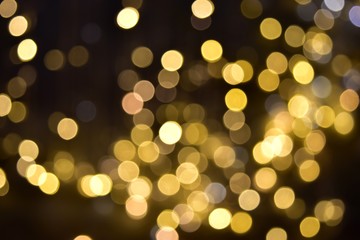 Glittering bokeh circular gold on black  background .