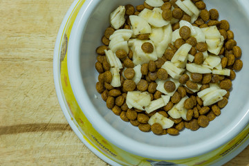 Dog food cereal mixed with banana in the bowl