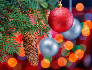 Christmas red ball with fir branch and cone. Focus concept.