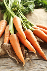 Fresh and sweet carrot on a grey wooden table