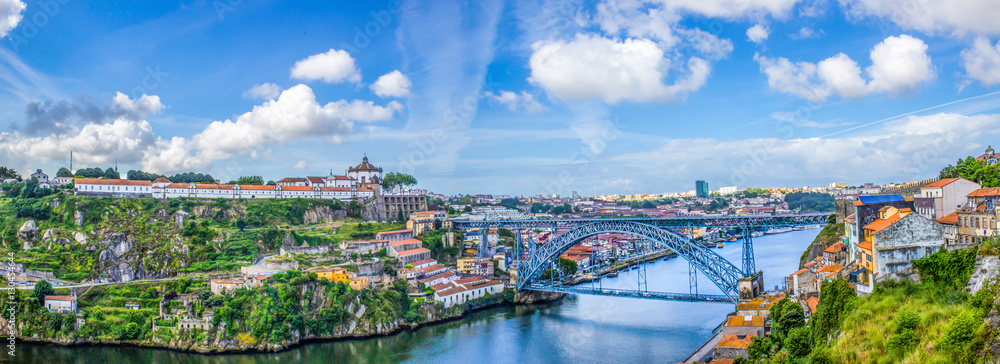View of the historic city of Porto, Portugal with the Dom Luis bridge and blue sky / Panoramic view from the city of Porto in Portugal / Ancient city Porto,metallic Dom Luis bridge. - obrazy, fototapety, plakaty 