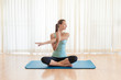 © kieferpix - Woman doing doing yoga stretch indoors.