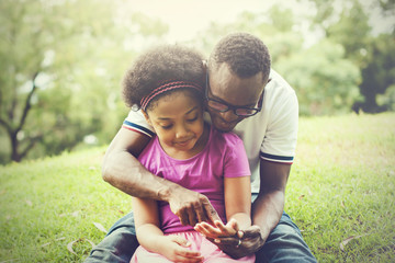 African American family playing together in the outdoor park