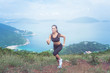 © undrey - Fitness female athlete wearing black sportswear doing cardio exercise, running in mountains with inspirational sea view