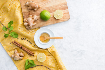 herbal with fresh mint, honey, lemon, ginger cinnamon on carpet background. Top view, copy space..