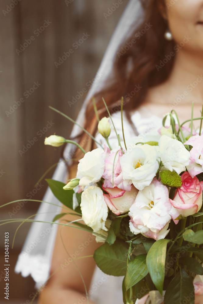 Bride with flower bouquet on her wedding day