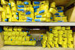 Yellow nylon soft lifting slings stacked in piles.