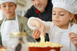 © goodluz - Pastry chef watching kids preparing apple pie
