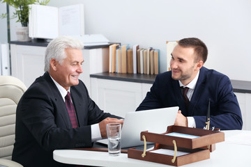 Wall Mural - Young man with notary at office