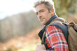 © goodluz - Hiker with backpack walking in the mountain