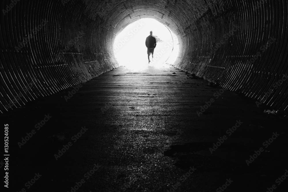 light at the end of the tunnel with silhouette of man - obrazy, fototapety, plakaty 