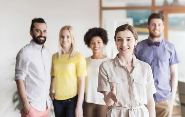 Canvas Print - woman making handshake over creative office team