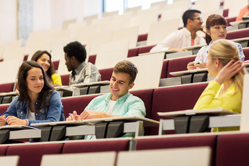 group of students with notebooks in lecture hall