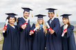 © Syda Productions - happy students in mortar boards with diplomas