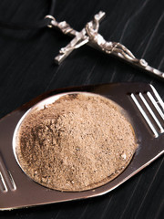 Wall Mural - Cross and ash - symbols of Ash Wednesday. Shallow depth of field.