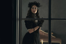 Vintage Victorian Woman In Black Dress Standing Behind Window Wi