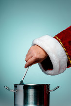 The Santa Hand Holding A Ladle Or Kitchen Spoon