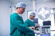 © WavebreakmediaMicro - Surgeon wearing surgical gloves in operation theater