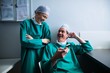 © WavebreakmediaMicro - Happy surgeons interacting while using mobile phone