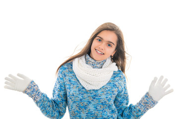 Beautiful little girl in cap and scarf isolated on white. Funny portrait of a girl in a blue knit sweater and white scarf. Space for text. Portrait of fashionable girl in winter clothes 
