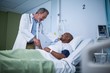 © WavebreakMediaMicro - Happy doctor and patient shaking hand in ward