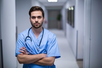 Wall Mural - Portrait of male nurse standing in corridor