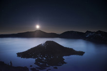 Scenic View Of Wizard Island In Crater Lake Against Sky At Night