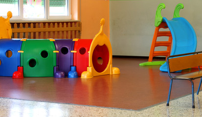 Wall Mural - a tunnel shape game and a slide in the large hall of kindergarte