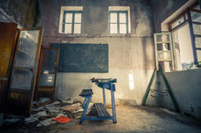 Ruined Board With A Desk In An Abandoned Old School Classroom.