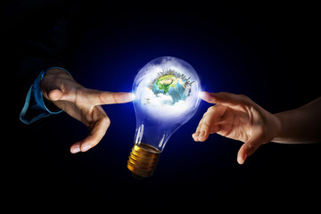 Wall Mural - hand pointing light bulb . mixed media