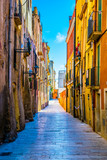 Fototapeta Uliczki - view of a colorful narrow street in the historical center of spanish city tarragona