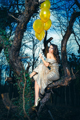 elegant fashion woman with balloons  in forest