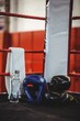 Boxing gloves, headgear, water bottle and a towel in boxing ring