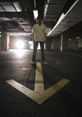 Wall Mural - Man and arrow marking in parking lot