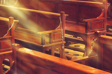 Wooden Church Pews In Church And Rosary Beads With Sunlight