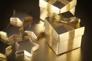 Sticker - Gift boxes and stars on golden background