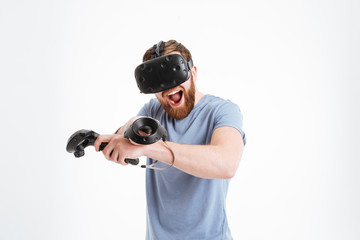 Poster - Screaming happy bearded young man wearing virtual reality device