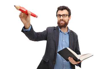 Canvas Print - Young teacher writing with a pencil and holding a book