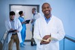 © WavebreakMediaMicro - Portrait of male doctor holding file in corridor