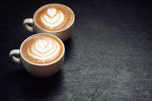 Two Cups Of Coffee On Black Rustic Background