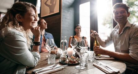 Group of friends enjoying an evening meal at a restaurant