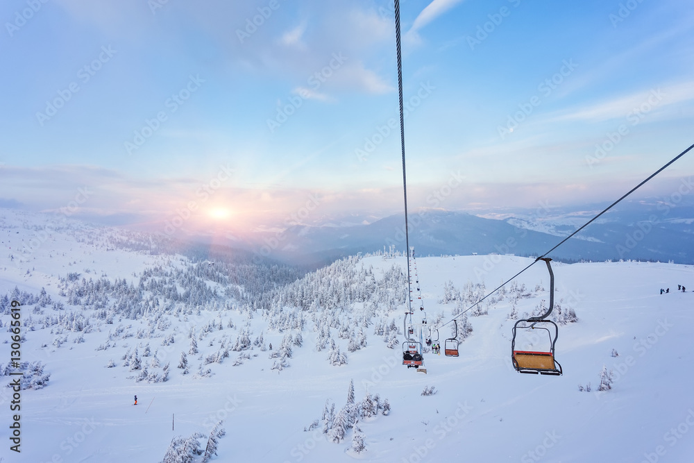 Obraz na płótnie Ski lift with seats going over the mountain and paths from skies w salonie